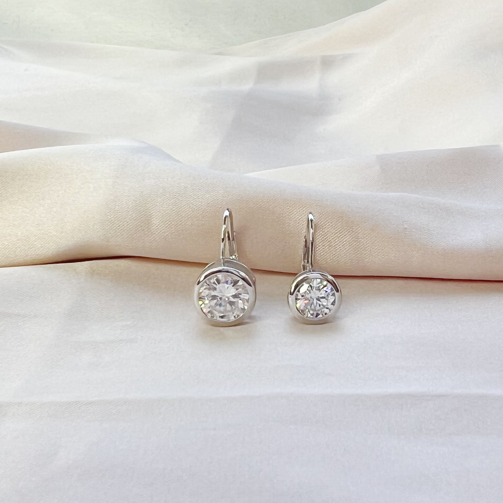 Platinum Plated 4ct Round Moissanite Bezel Set Dangling Earrings in Sterling Silver